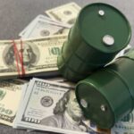 U.S. Allies Forced to Shut Oil — Prices Skyrocketing Two green barrels placed on a pile of hundred dollar bills