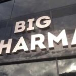 Sign displaying the words BIG PHARMA on a glass building