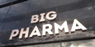 Sign displaying the words BIG PHARMA on a glass building
