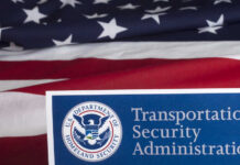 Transportation Security Administration sign in front of an American flag