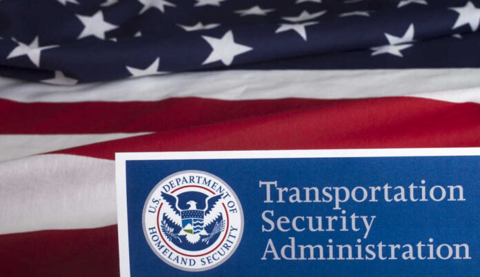 Transportation Security Administration sign in front of an American flag