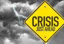 Allies ABANDON Trump — Strait Crisis Deepens Yellow sign reading Crisis Just Ahead with stormy sky