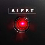 Offshore Drone Threat Against U.S. Alarms FBI Red alert light against black background, text ALERT.