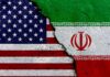 A cracked surface displaying the flags of the USA and Iran