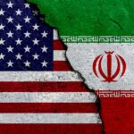 Iranian Attacks DEVASTATED Some U.S. Bases A cracked surface displaying the flags of the USA and Iran