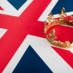 King Returns — 250 Years After Founders Rebelled A golden crown resting on the Union Jack flag
