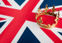 A golden crown resting on the Union Jack flag