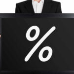 Man holding blackboard with white percent symbol.