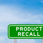 RECALL: Injuries Include Punctured Organs! Green sign with product recall text and sky background