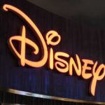 Disney Slammed With License Threat Illuminated Disney logo against a dark background