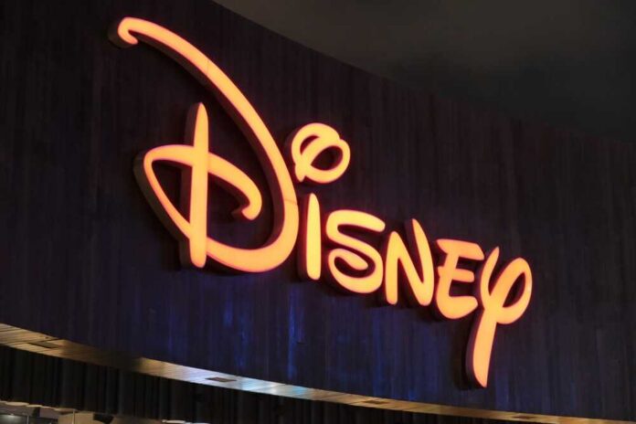 shutterstock_2341277801.jpg Illuminated Disney logo against a dark background