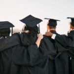 43 Million ‘Almost Graduates’ Haunt America Group of graduates standing together with arms around each other, wearing caps and gowns
