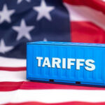 Tariffs BACKFIRE — Used Car Prices Explode Shipping container reading tariffs on the American flag