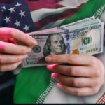 Iran War DOUBLES Fuel Prices — Flights Vanishing Hands holding a $100 bill with American and Iranian flags in the background