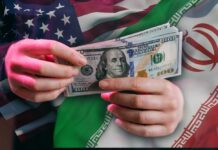 Hands holding a $100 bill with American and Iranian flags in the background