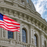 Warning Ignored? Senators Demand Answers American flag in front of ornate building facade.