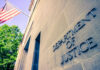 DOJ Seeks Death For These Two Murders Department of Justice building with American flag.