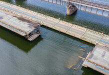 Bridge Collapse Nightmare: Shocking Conspiracy Damaged concrete bridge with collapsed sections over a river