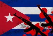 Cuban flag with silhouettes of guns and red splashes