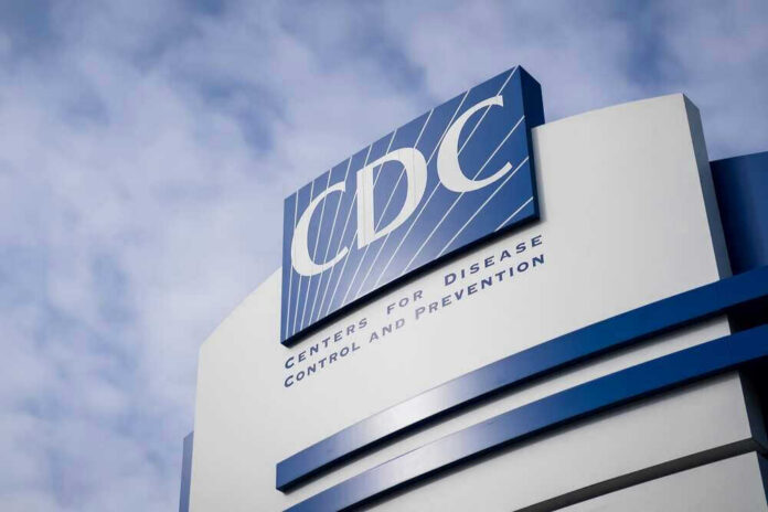 shutterstock_2123545061.jpg CDC building sign against a cloudy sky.