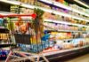 Shock: Memorial Day Cookout Costs Skyrocket! Shopping cart filled with various groceries in a supermarket aisle