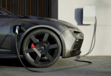EV Maker’s SHOCKING Loss – 70-Year Streak Broken! Electric car charging at a station.