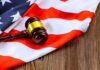 American Flag Blue Sparks Lawsuit Fight A gavel resting on an American flag