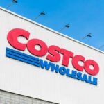 Costco Members RAGE Over Menu Change?! Costco Wholesale store sign against a blue sky