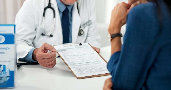 Doctor discussing a medical form with a patient