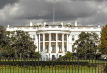 White House Shootout: Suspect Dead; Bystander Wounded The White House with dark clouds overhead.