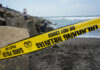 Resort Paradise Turns Deadly Yellow police tape by rocky ocean shore