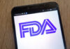 FDA Bombshell — Sunscreen Rules Upended Close-up of a smartphone displaying the FDA logo