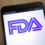 FDA Bombshell — Sunscreen Rules Upended Close-up of a smartphone displaying the FDA logo