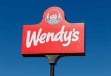 Wendy's restaurant sign against a clear blue sky