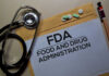 Big Cancer Win For A Select Few? Stethoscope and medication on a folder labeled FDA