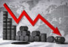 Graph depicting a decline in oil prices with barrels in the foreground