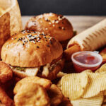 Burger War Erupts – Big Moves Happening Now A variety of fast food items including burgers, onion rings, and chips