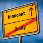 VIDEO: Black Teen Shot In Back — Jury Says Not Guilty A yellow road sign displaying 'Innocent' pointing up and 'Guilty' crossed out
