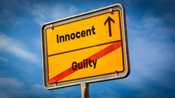 Street,Sign,The,Direction,Way,To,Innocent,Versus,Guilty A yellow road sign displaying 'Innocent' pointing up and 'Guilty' crossed out