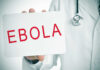 Ebola Scare Locks Down Another City Doctor holding a sign about Ebola