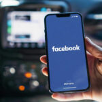 Surprise Cash Hits Facebook Veterans Phone displaying Facebook app in a car
