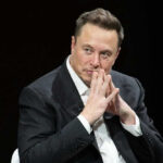 Musk’s Wild IPO Makes Him THIS Wealthy?! Elon Musk in suit thinking.