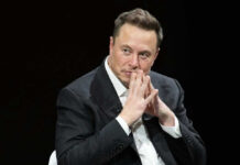 Musk’s Wild IPO Makes Him THIS Wealthy?! Elon Musk in suit thinking.