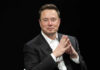 MUSK’S $1T Taunt Ignites Wild Frenzy Elon Musk in a suit talking.