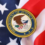 Citizenship Crackdown Explodes — Who’s Next? Department of Justice seal on American flag.