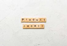 Wooden letter tiles forming words on a white textured surface