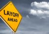 Bombshell News: THIS Blamed For 40% Of Layoffs Yellow warning sign indicating layoffs ahead against a cloudy background