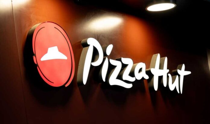 Warsaw,,Poland,-,29,December,2024:,Large,Sign,With,The Illuminated Pizza Hut sign on a dark background