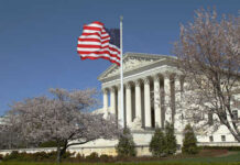 Sotomayor Fumes As Red State Map Survives U.S. Supreme Court building with an American flag and cherry blossom trees