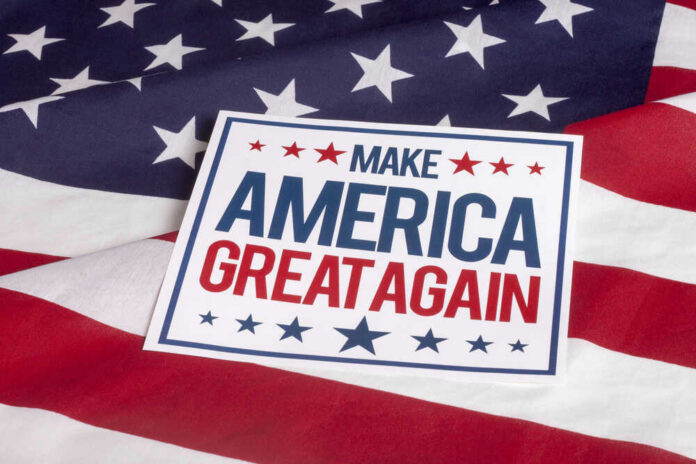 shutterstock_307140605 Sign saying Make America Great Again on American flag.